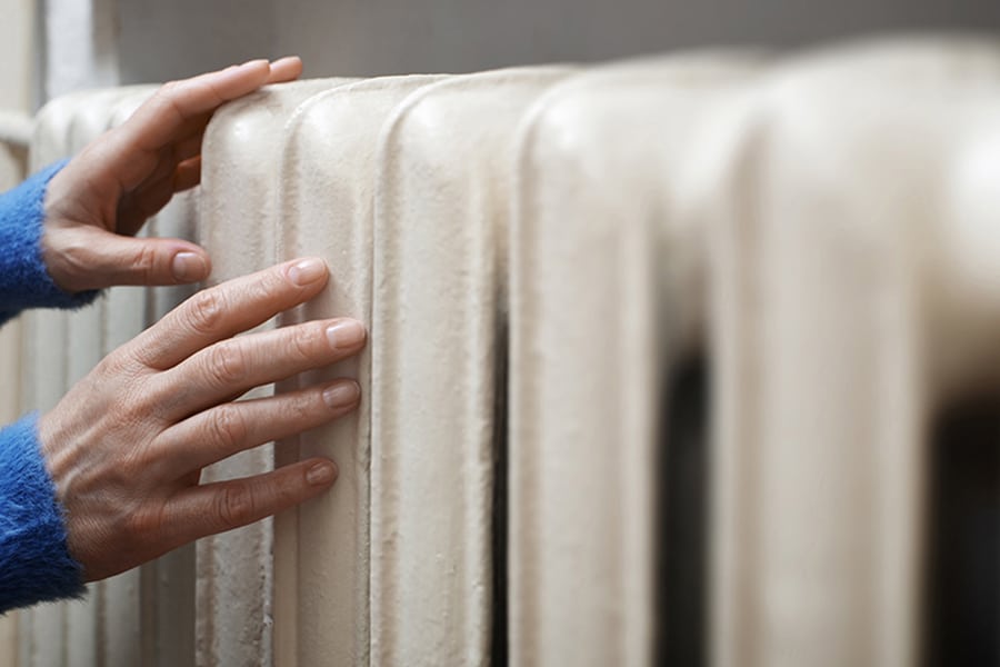 Boiler Engineer checking the heat from a radiator at a callout